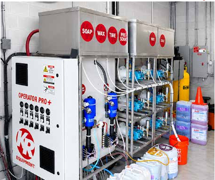 The Wash Stop equipment room with pumps, chemical lines, controls, and wash products